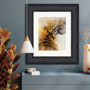 Op de afbeelding: Een aquarel schilderij van een brulende tijger met zijn bek open. De tijger is oranje en zwart met witte strepen. De achtergrond is lichtbruin met spatten van geel en wit.
