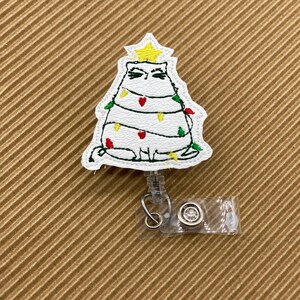 Cat tangled in Christmas lights retractable badge reel