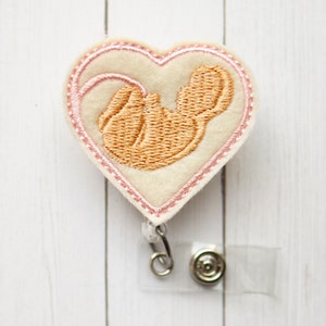Baby in the womb, retractable ID badge reel, pink.