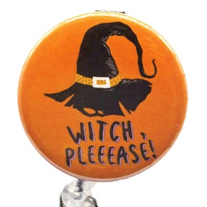 May include: A round orange button with a black witch hat and the text "WITCH, PLEEEASE!"  The button is attached to a clear retractable badge holder.