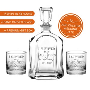 May include: A clear glass decanter with a faceted stopper and two matching lowball glasses. Each piece features the sand-carved text I SURVIVED my DAUGHTER'S wedding 10.14.2022. The set is presented as a collection of three distinct glass items.