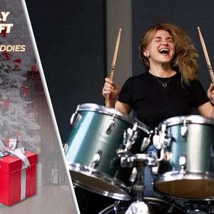 May include: Image features a drummer playing a teal drum set, holding drumsticks. Text reads "Perfectly Tuned Gift for Your Drummer Buddies." Presents with bows and drumsticks are on the left. Red and white Christmas ornaments hang in the background.