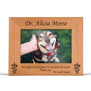 May include: A wooden picture frame with a photo of a dog and the text "Dr. Alicia Morse" and "The influence of a great Vet can never be erased. Thank you - The Smith Family".