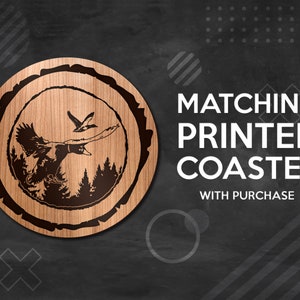 May include: A wooden coaster with a laser-engraved design of two flying ducks in a forest setting. The coaster is round and has a natural wood finish. The text "MATCHING PRINTED COASTER WITH PURCHASE" is displayed on a black background.