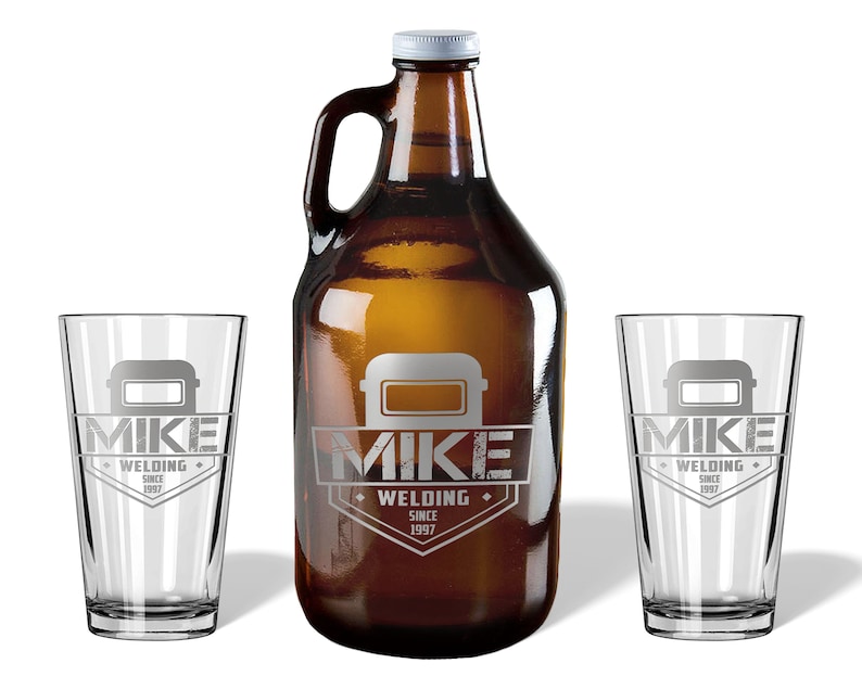 May include: A brown glass growler with a white cap and handle, flanked by two clear pint glasses. All items feature a gray welding mask graphic and the text "MIKE WELDING SINCE 1997".