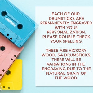 May include: A colorful image featuring three vintage cassette tapes in blue, pink, and yellow, arranged diagonally. A white card displays text about personalized hickory wood drumsticks, including details about engraving and wood grain variations.