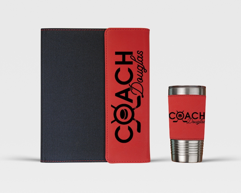 May include: A red and black leatherette notebook and a red and silver tumbler with the text "COACH Douglas" printed on both items.