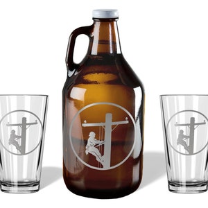 May include: A brown glass growler with a white cap and two clear glass pint glasses. Each item features an etched circular design showing a utility worker climbing a wooden power pole. The set includes one large jug and two matching drinking glasses.