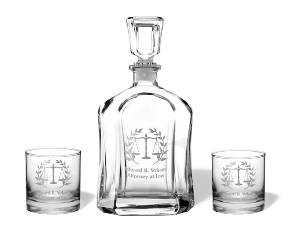 A Scales of Justice-themed engraved whiskey set made specifically for lawyers — niche enough to feel genuinely thoughtful rather than generic barware.
