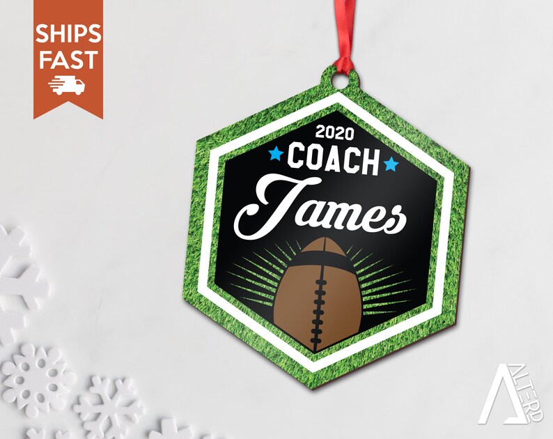 May include: A green and black hexagonal Christmas ornament with a white border. The ornament features a football, the text "2020 COACH James" and two blue stars.