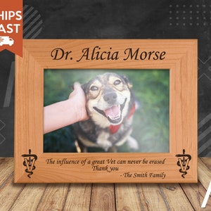May include: A wooden picture frame with a personalised inscription for Dr. Alicia Morse. The inscription includes the text "The influence of a great Vet can never be erased. Thank you - The Smith Family". The frame includes a photo of a dog.