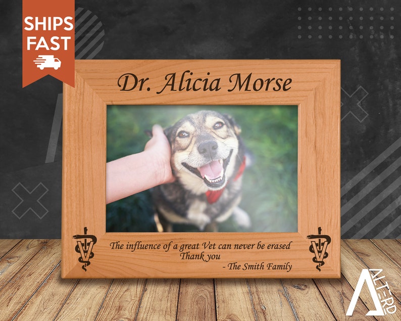 May include: A wooden picture frame with a personalised inscription for Dr. Alicia Morse. The inscription includes the text "The influence of a great Vet can never be erased. Thank you - The Smith Family". The frame includes a photo of a dog.