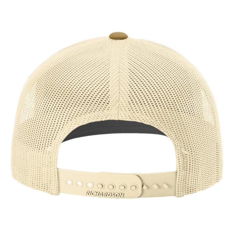 May include: A beige mesh trucker hat with a brown button on top. The hat has a black underside and a brown adjustable strap with the word "RICHARDSON" printed on it.