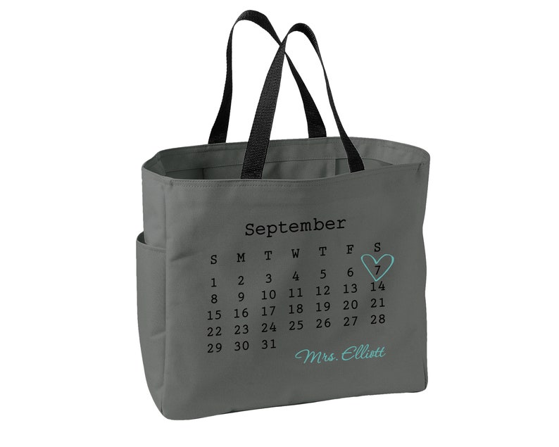 May include: A white ceramic mug with a black handle and the text "But First, Coffee" in a black, bold font. The mug is on a white surface.