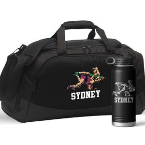 May include: Black duffel bag and water bottle featuring a wrestling graphic and the name "SYDNEY" in white. The bag has a shoulder strap and top handle. The water bottle is black with a silver graphic.