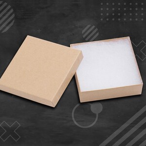 May include: Two open brown cardboard gift boxes with white tissue paper lining. The boxes are on a black background.