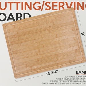 May include: A rectangular bamboo cutting board with a drip ring. The board measures 13 3/4 inches by 11 inches. The text "BAMBOO" is printed in red on the bottom right corner of the board.