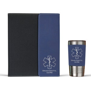 May include: A set of personalized gifts featuring a blue and black leatherette journal, a matching blue leatherette wallet, and a stainless steel travel mug. The mug has a silver medical symbol and the text "Brad Coutts, CC-PM".