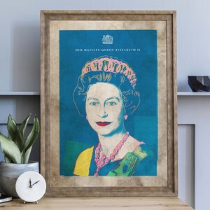 May include: A framed print of a pop art portrait of Queen Elizabeth II. The portrait is in a blue, yellow, and green color scheme. The text "HER MAJESTY QUEEN ELIZABETH II" is at the top of the print.