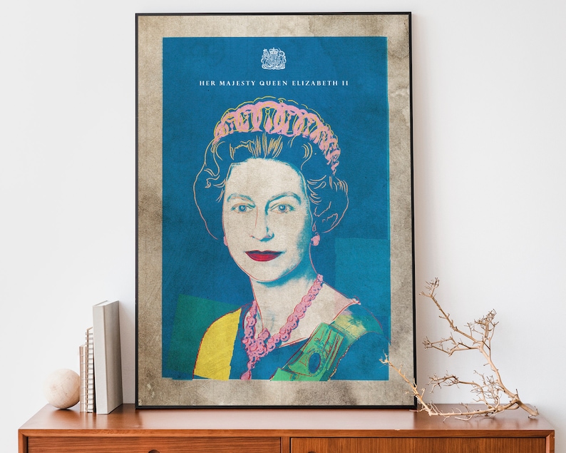May include: A vintage-style poster featuring a pop art portrait of Queen Elizabeth II. The poster has a blue background with a yellow and green sash, and the Queen is wearing a pink crown and necklace. The text "HER MAJESTY QUEEN ELIZABETH II" is printed at the top of the poster.