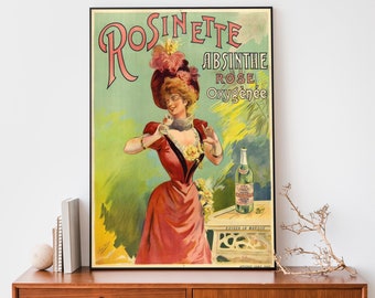 May include: Vintage advertisement poster for Rosinette Absinthe Rose Oxygénée. The poster features a woman in a red dress and hat, holding a glass. A bottle of absinthe is on a table. The poster has a green and pink color scheme.