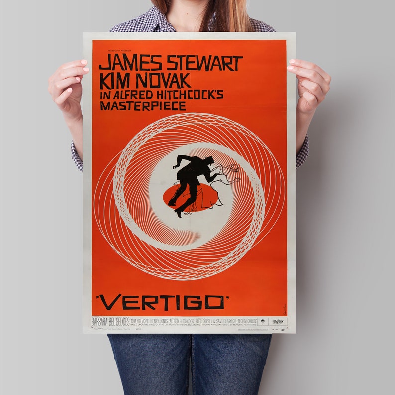 May include: A vintage movie poster for the film "Vertigo" starring James Stewart and Kim Novak. The poster features a red background with a swirling black and white design and the title "Vertigo" in white text.