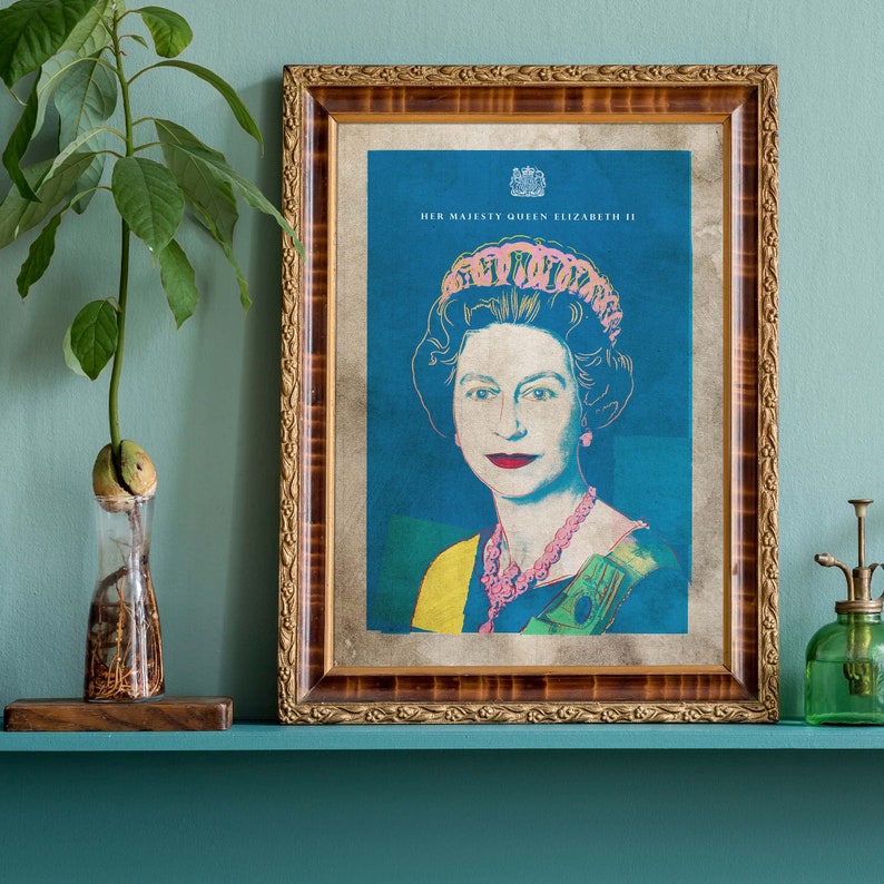 May include: A framed portrait of Queen Elizabeth II in a blue and pink color scheme. The portrait is set against a blue background and features the Queen wearing a crown and a necklace. The text "HER MAJESTY QUEEN ELIZABETH II" is printed at the top of the portrait.