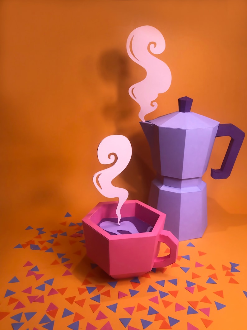 May include: A purple coffee pot with a pink coffee cup and steam coming out of both. The coffee pot and cup are made of paper and are sitting on a orange background with confetti.