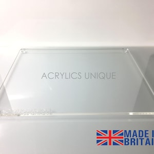 May include: A clear acrylic sheet with the text "Acrylics Unique" printed on it. The sheet is made in Britain.