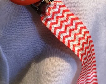 Whimsical Giraffe will keep track of your babys pacifier/Binky! Clip on orange chevron print elastic, can be used on all types of pacifers