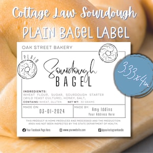 May include: A white label with black text for a plain sourdough bagel. The label says "Cottage Law Sourdough Plain Bagel Label" and "Oak Street Bakery". It includes the ingredients, net weight, and date made. The label is 3.33 inches by 4 inches.