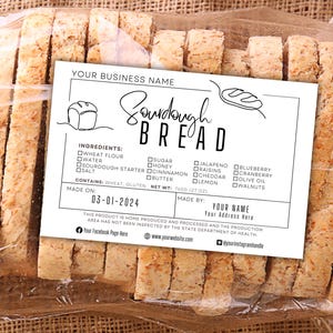 May include: Sliced sourdough bread in a clear plastic bag, with a label that reads "Sourdough Bread." The label lists ingredients and the date made. The bread slices are light brown and have a textured surface.