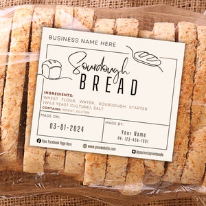 May include: A close-up of a loaf of sourdough bread wrapped in plastic. The label reads "Sourdough Bread" and lists the ingredients: wheat flour, water, sourdough starter, and salt. The label also states that the bread was made on 03-01-2024.