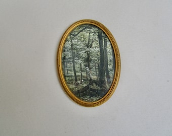 Old, delicate, oval brass picture frame for hanging