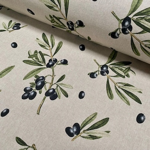 May include: Beige fabric featuring a repeating pattern of olive branches and black olives. The leaves are green, and the olives are black. The fabric has a natural, textured appearance, suitable for home decor or crafting projects.