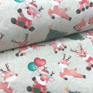 May include: A light beige fabric featuring a repeating pattern of cartoon reindeer with red noses, some wearing Santa hats and scarves, holding balloons or gifts, interspersed with small green Christmas trees and yellow stars.
