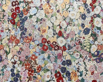 May include: A close-up view of a floral tapestry with a dense pattern of colorful flowers. The flowers are in shades of red, blue, yellow, pink, and white, creating a vibrant and textured surface. The overall effect is reminiscent of a meadow in bloom.