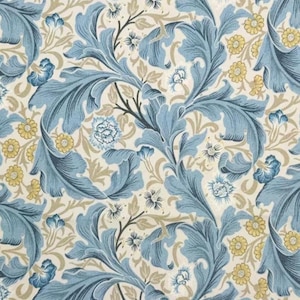 May include: A repeating pattern with large, stylized blue leaves and smaller yellow and blue floral accents on a cream background. The design has a vintage, botanical feel, with intricate details and a classic aesthetic.