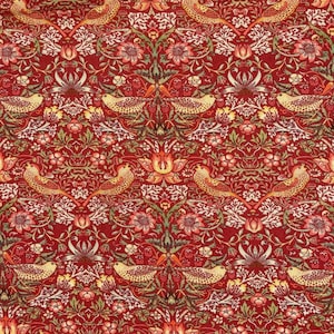 May include: A fabric featuring a repeating pattern of birds and floral motifs in shades of red, orange, yellow, and green. The design includes stylised flowers, leafy vines, and small birds arranged in a symmetrical, dense, and intricate composition.