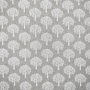 May include: Grey fabric featuring a repeating pattern of white trees. Each tree has a trunk and a full, rounded crown of leaves. The trees are evenly spaced across the fabric.