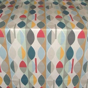 May include: Fabric featuring a repeating pattern of stylized leaf shapes in various colours. The design incorporates teal, red, yellow, grey, and light blue elements on a cream background. Vertical stripes add structure to the design.