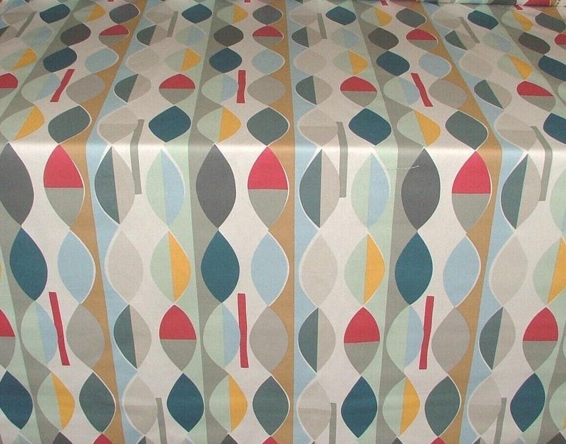 May include: Fabric featuring a repeating pattern of stylized leaf shapes in various colours. The design incorporates teal, red, yellow, grey, and light blue elements on a cream background. Vertical stripes add structure to the design.