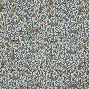 May include: A patterned fabric featuring a design of birds, pomegranates, and foliage. The pattern includes birds with red and yellow details, pomegranates in red and yellow hues, and blue-green leaves and branches on a cream backdrop.