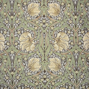 May include: A detailed textile pattern featuring a repeating floral design. The pattern showcases large, cream-colored flowers, green leaves, and small yellow blossoms against a backdrop of gray and brown. The overall aesthetic is reminiscent of vintage botanical illustrations.