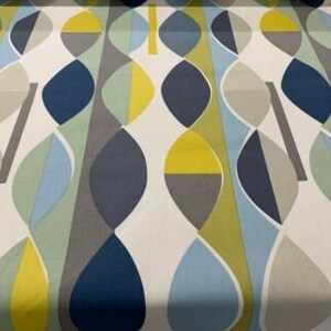May include: A fabric with a repeating abstract pattern. The design features elongated, leaf-like shapes in shades of blue, yellow, grey, and green against a white background. The pattern has a mid-century modern aesthetic.