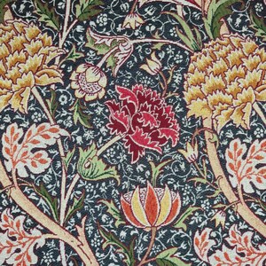 May include: A close-up of a floral fabric with a dark blue background. The design features large yellow and red flowers, along with orange and white leaves and green stems. The pattern is detailed and intricate.