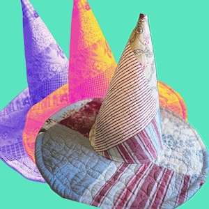 May include: A selection of handmade witch hats with a quilted design. The hats feature various patterns and colours, including red and white stripes, floral prints, and a blue and white floral pattern. The hats are set against a teal background.