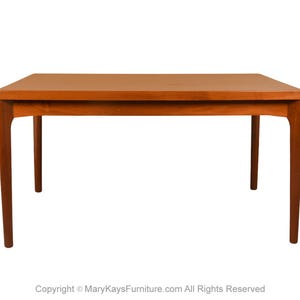 May include: A rectangular wooden table with a warm brown finish. The table has four legs and a simple, classic design. The table is approximately 48 inches long and 30 inches wide.