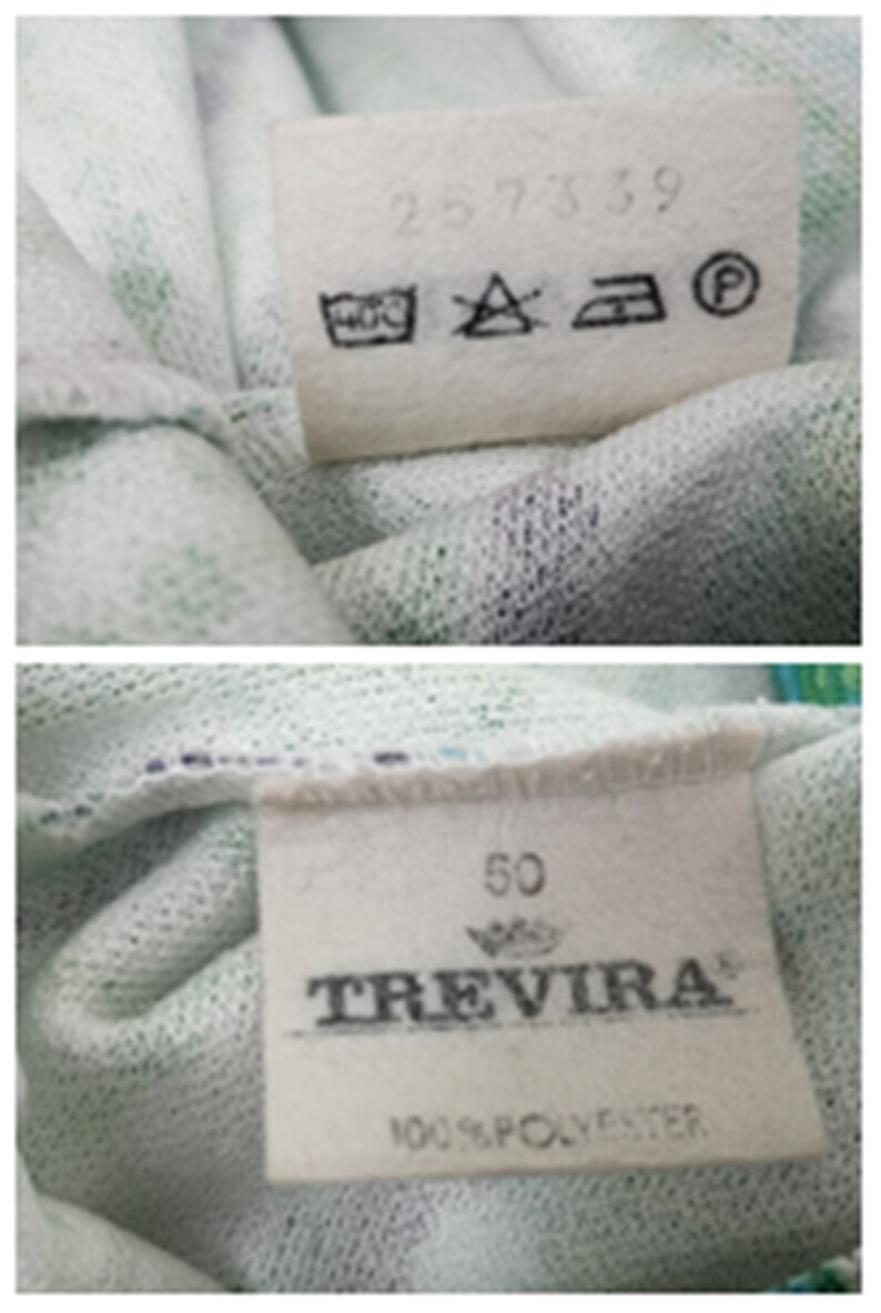 May include: White fabric label with black text and symbols. The text reads "257359" and "Trevira 100% Polyester". The symbols are for washing instructions. The label also has a number "50" printed on it.