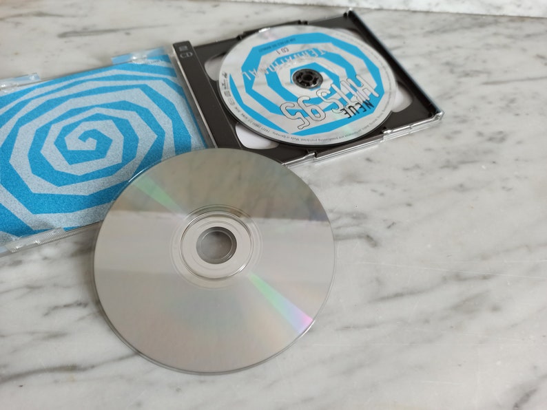 May include: A silver CD with a blue and white spiral design on the cover. The CD is titled "The 95's" and the artist is "MEULE".